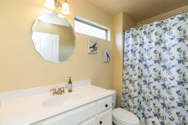 a bathroom with a sink toilet and mirror