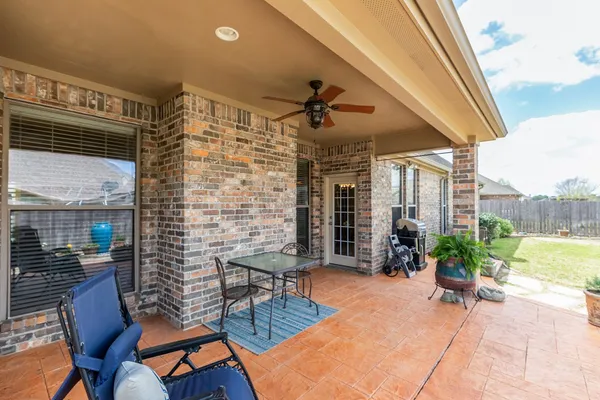 a outdoor space with patio the couch and potted plants