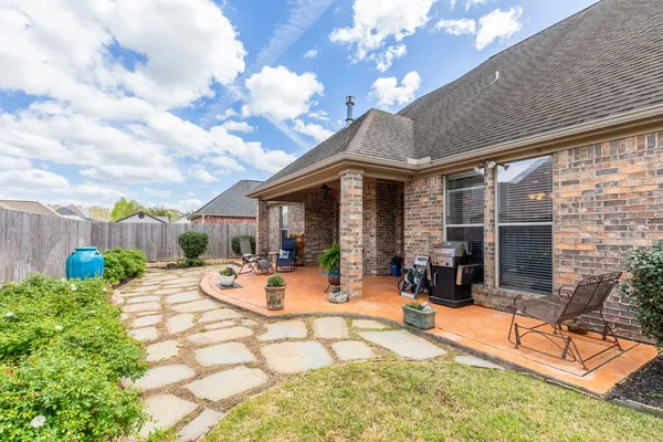 a view of a house with backyard porch and sitting area