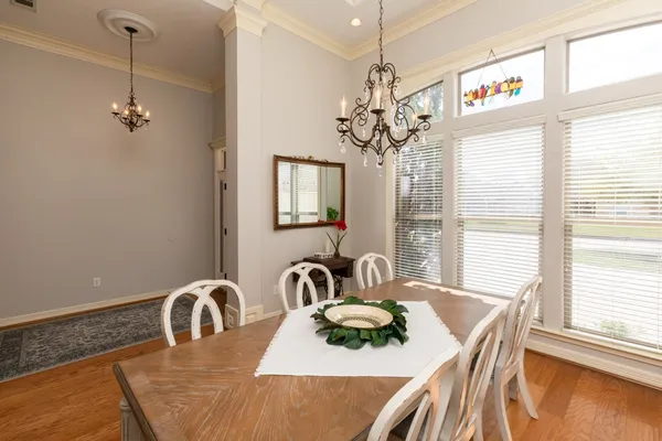 a dining room with furniture a chandelier and window
