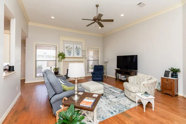 a living room with furniture a rug and a flat screen tv