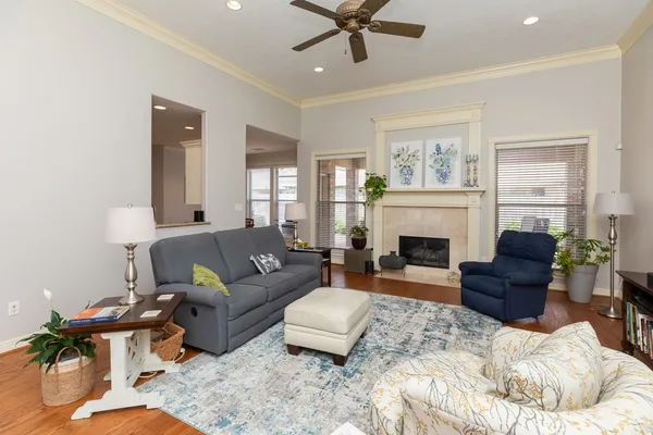 a living room with furniture fireplace and a window