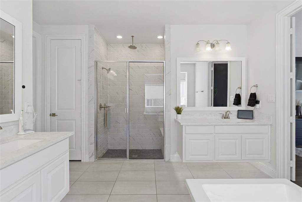 7548 Ridge Lane Grand Prairie, TX 75054 - Photo 20 of 35 Bathroom featuring two vanities, a stall shower, and light tile patterned flooring