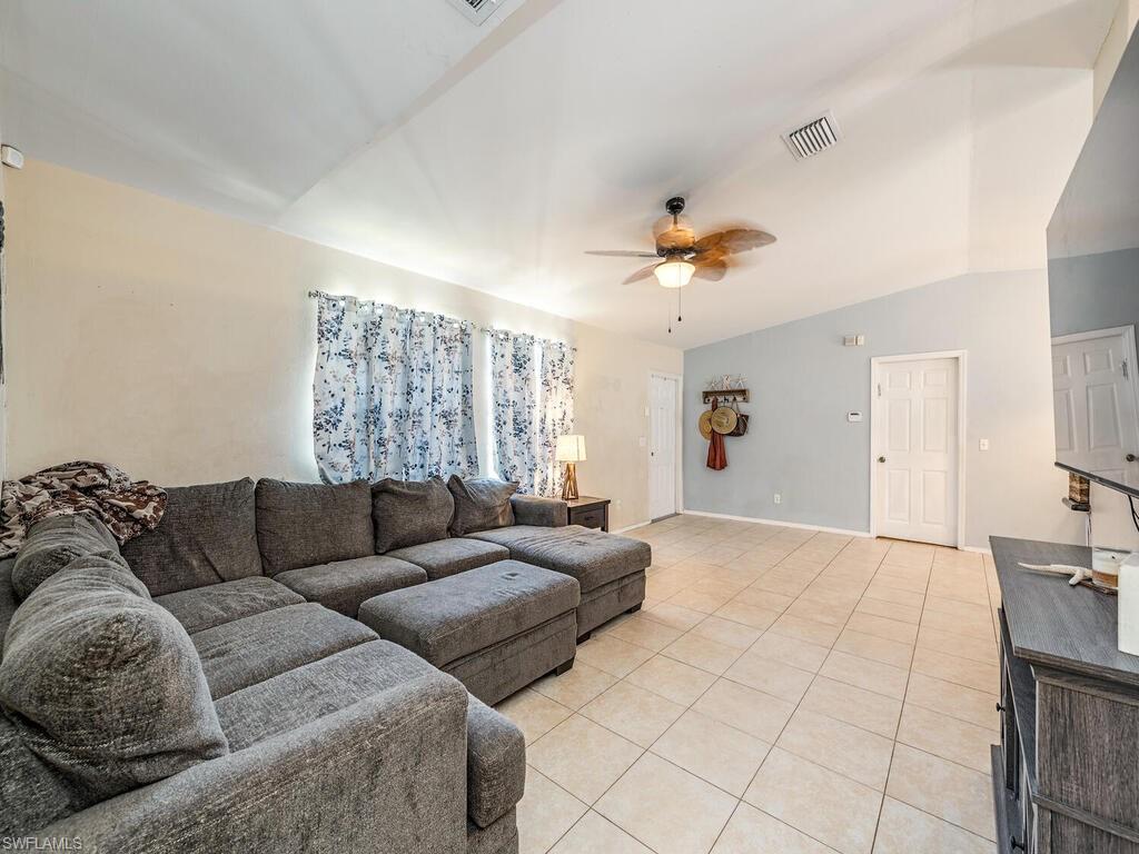 18351 Camellia Road Fort Myers, FL 33967 - Photo 2 of 11 a living room with furniture and a chandelier