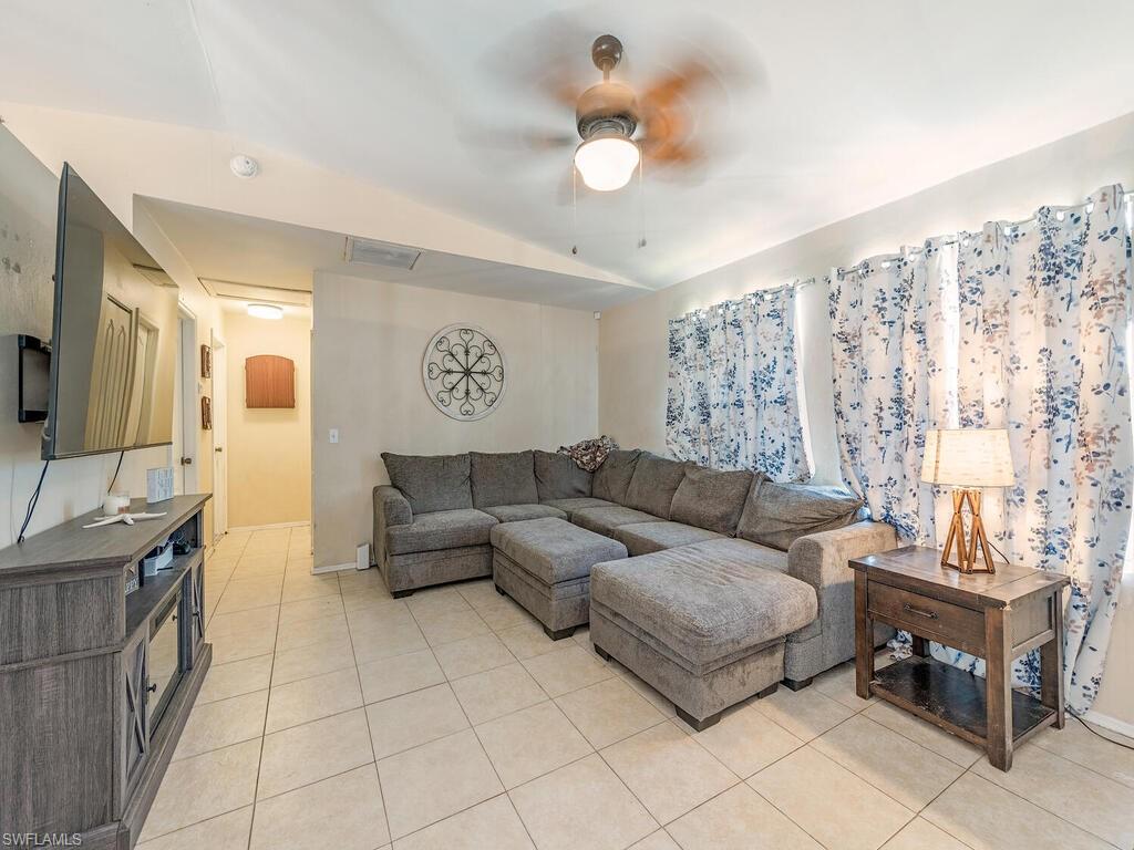 18351 Camellia Road Fort Myers, FL 33967 - Photo 3 of 11 a living room with furniture and a flat screen tv