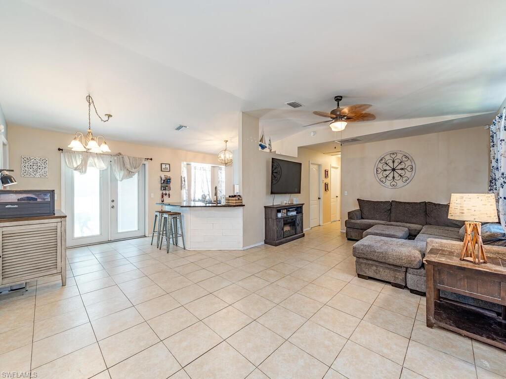 18351 Camellia Road Fort Myers, FL 33967 - Photo 4 of 11 a living room with furniture and a dining table with kitchen view