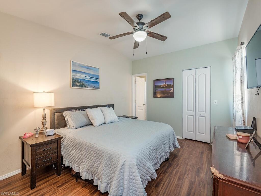 18351 Camellia Road Fort Myers, FL 33967 - Photo 7 of 11 a bed room with a bed and a chandelier