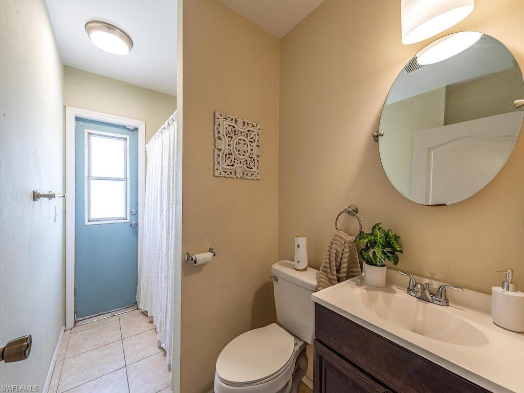 18351 Camellia Road Fort Myers, FL 33967 - Photo 10 of 11 a bathroom with a sink mirror vanity and toilet