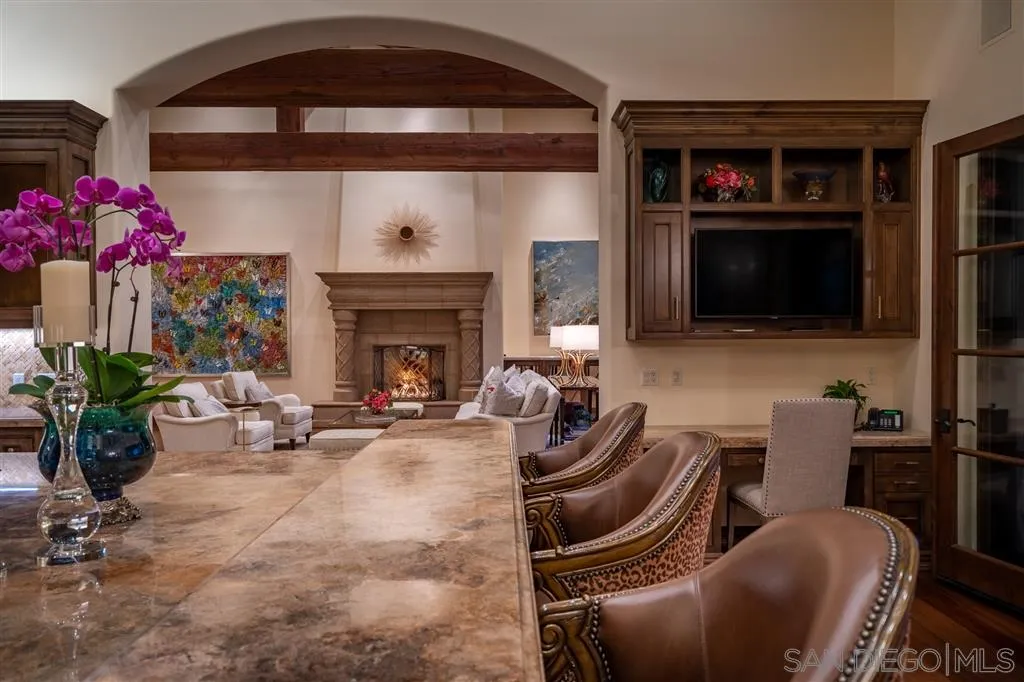 6266 Strada Fragante Rancho Santa Fe, CA 92091 - Photo 14 of 25 a living room with furniture a flat screen tv and a fireplace