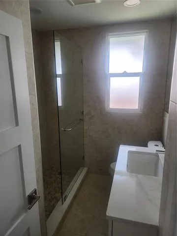 a bathroom with a toilet and a shower
