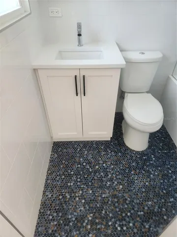 a bathroom with a toilet and a sink