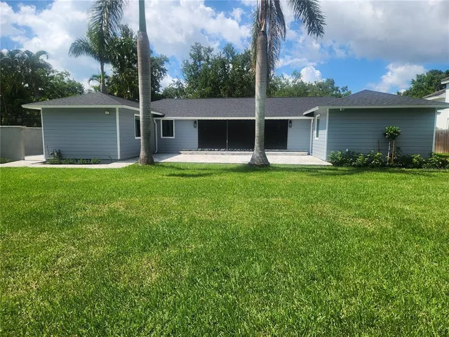 front view of a house with a yard and a garage