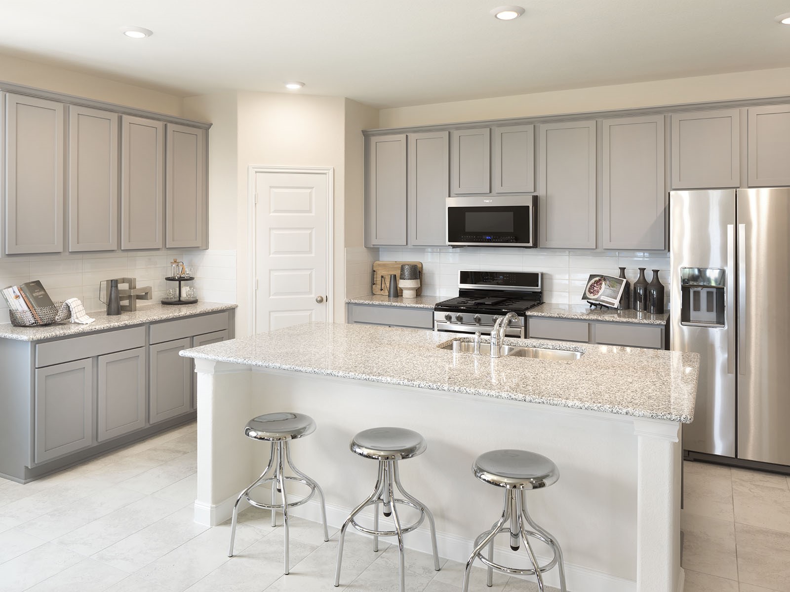 16254 Parish Pointe Court Conroe, TX 77302 - Photo 1 of 14 a kitchen with stainless steel appliances a stove a sink a microwave a refrigerator and cabinets