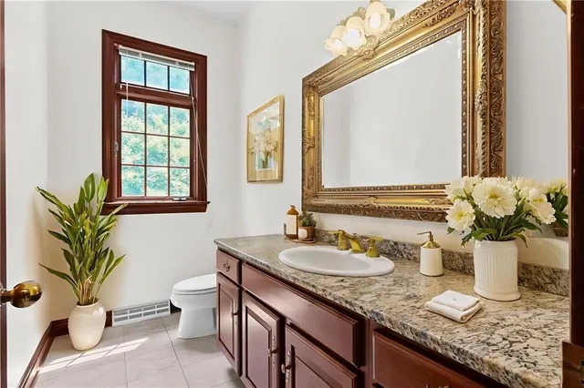 a kitchen with kitchen island granite countertop wooden cabinets and a refrigerator