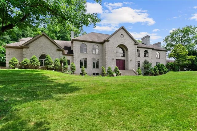 a view of a house with yard and a garden