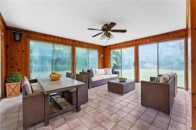 a living room with furniture a rug and a bookshelf