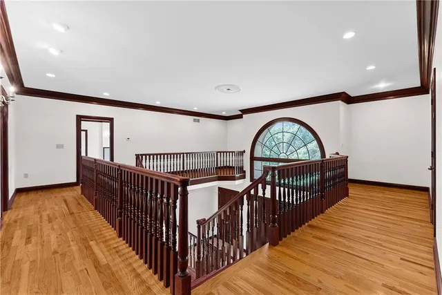 a spacious bedroom with a large bed and a large window