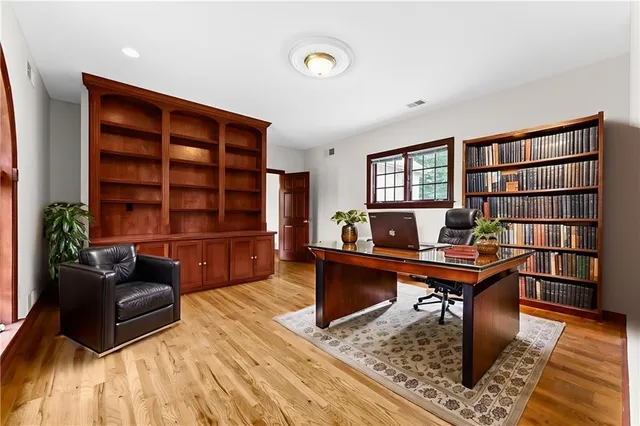 a bathroom with a tub a sink and mirror