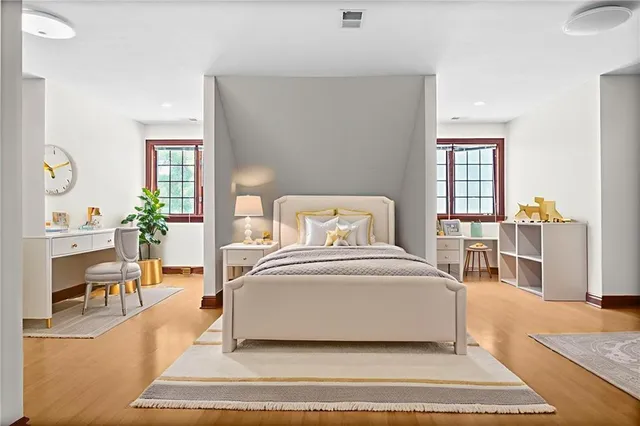 a view of an empty room with window and wooden floor