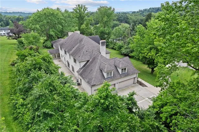 an aerial view of a house with a yard
