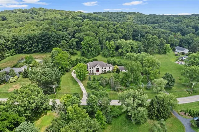 an aerial view of a house with a yard