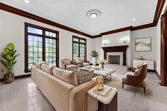 a view of an empty room with a fireplace and a window