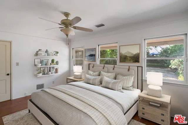 a bedroom with a bed and a large window