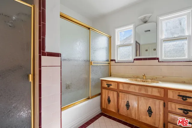 a bathroom with a sink a mirror and a bathtub