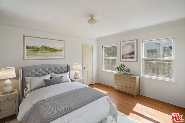 a bedroom with a large bed and a window