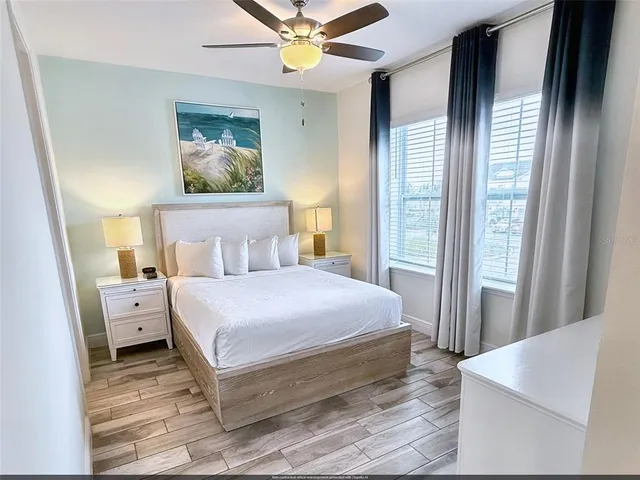 a bedroom with a bed and a chandelier