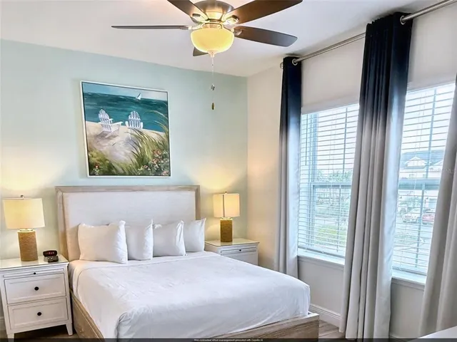 a bedroom with a bed and a painting on the wall