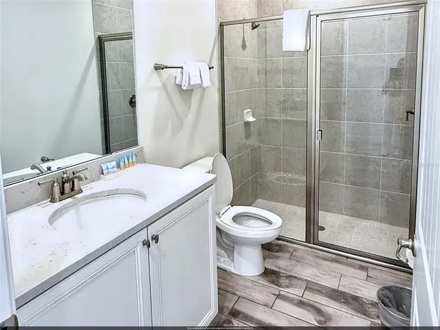 a bathroom with a sink toilet and shower