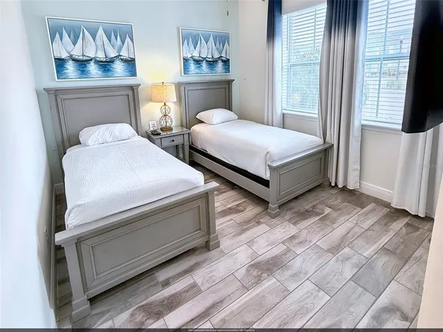 a bedroom with two beds and a window