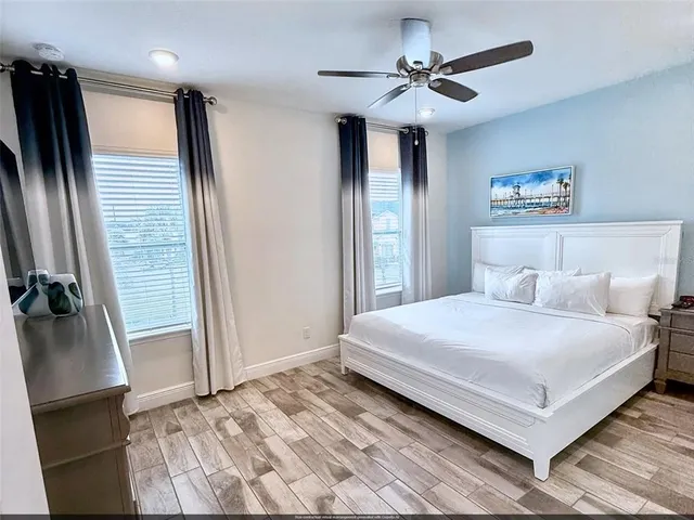 a bedroom with a large bed and a chandelier