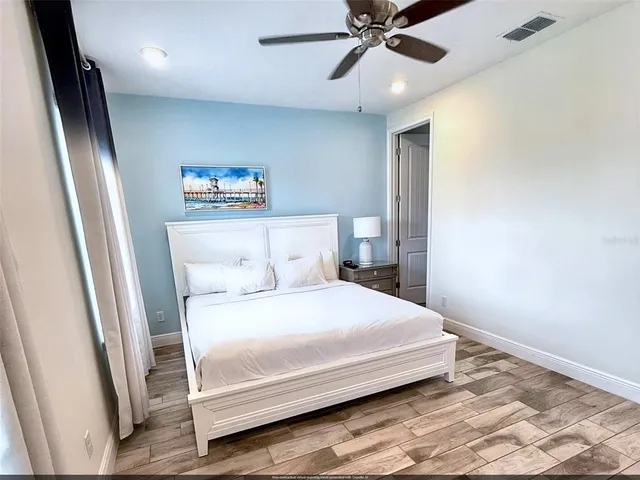 a bedroom with a bed and a large mirror