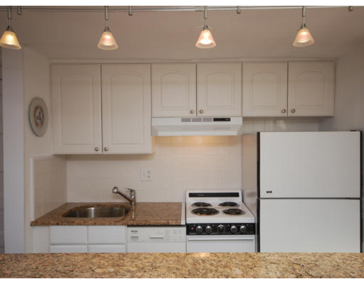 7 Fairfield Street, Unit 4 Boston, MA 02116 - Photo 6 of 13 a kitchen with granite countertop white cabinets and stainless steel appliances