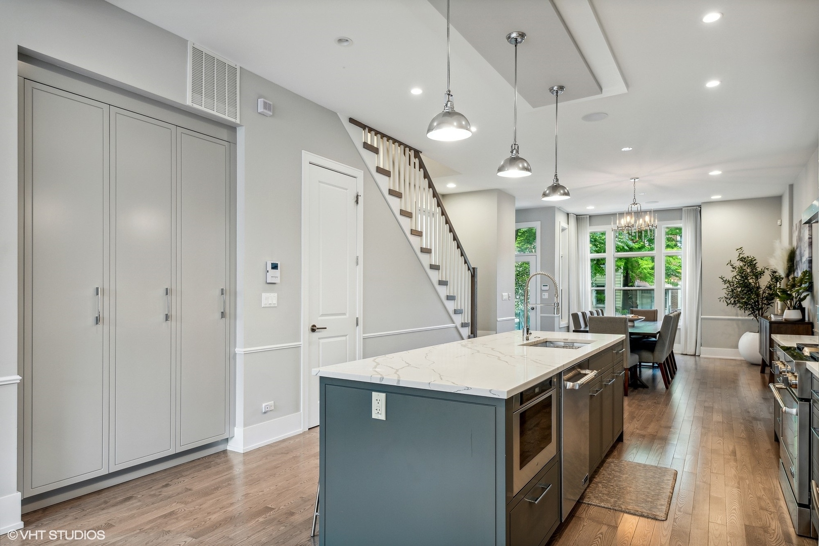 2062 North Bingham Street Chicago, IL 60647 - Photo 5 of 34 a kitchen with a table chairs and a chandelier