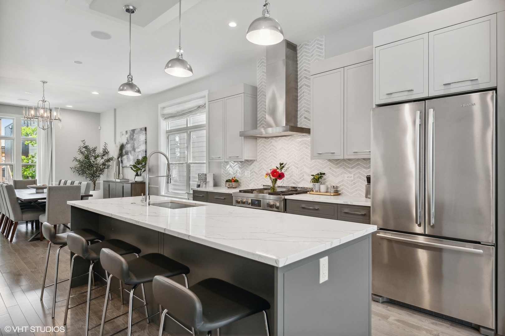 2062 North Bingham Street Chicago, IL 60647 - Photo 8 of 34 a kitchen with stainless steel appliances a table chairs stove and refrigerator