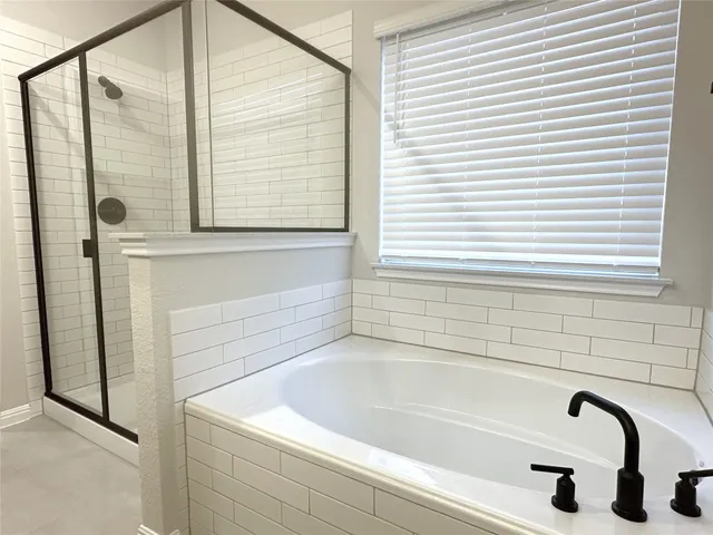 a bathroom with a double vanity sink and mirror