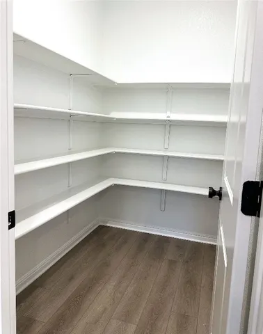 a view of a room with shelves on the wall