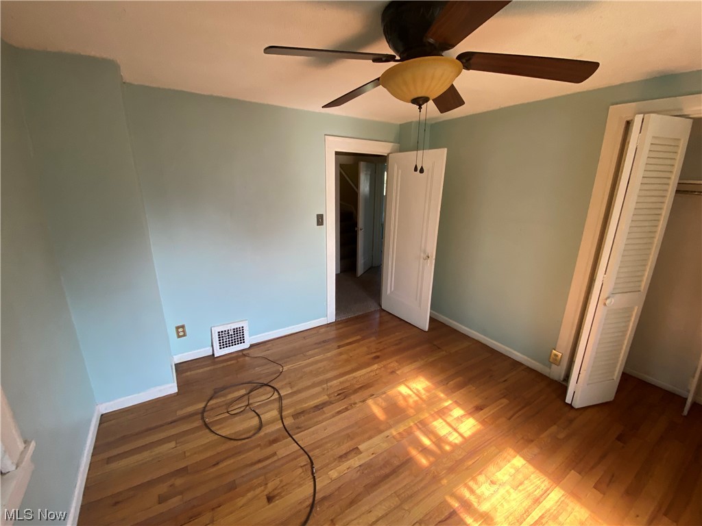 3630 Bainbridge Road Cleveland Heights, OH 44118 - Photo 14 of 21 Unfurnished bedroom featuring ceiling fan, dark hardwood / wood-style floors, and a closet