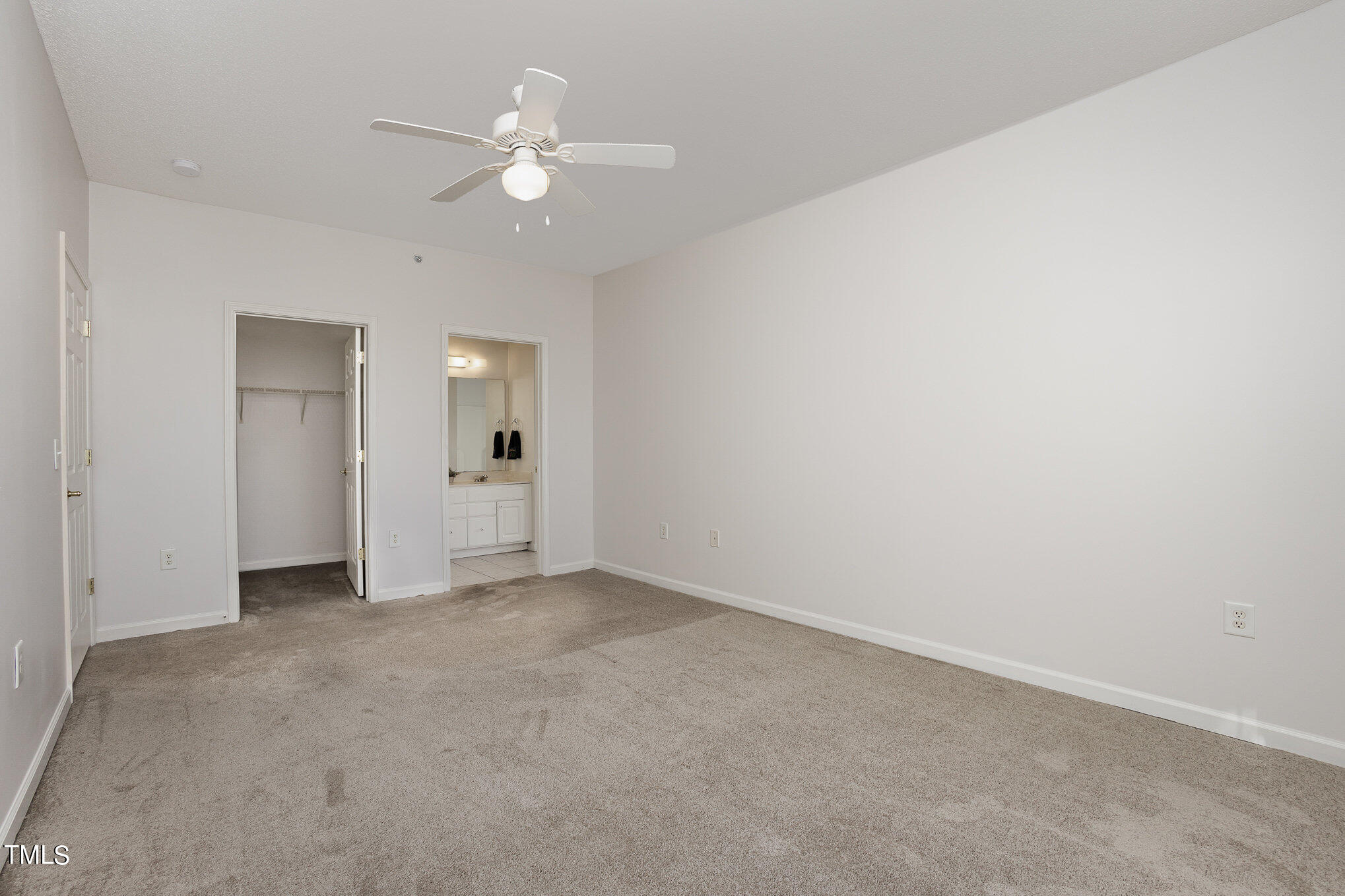 2500 Friedland Place, Unit 302 Raleigh, NC 27617 - Photo 9 of 15 an empty room with a ceiling fan and a window