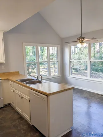 a room with natural light and hardwood floor