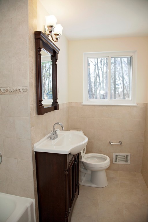 14 McAdams Road Framingham, MA 01701 - Photo 11 of 15 a bathroom with a toilet sink and mirror