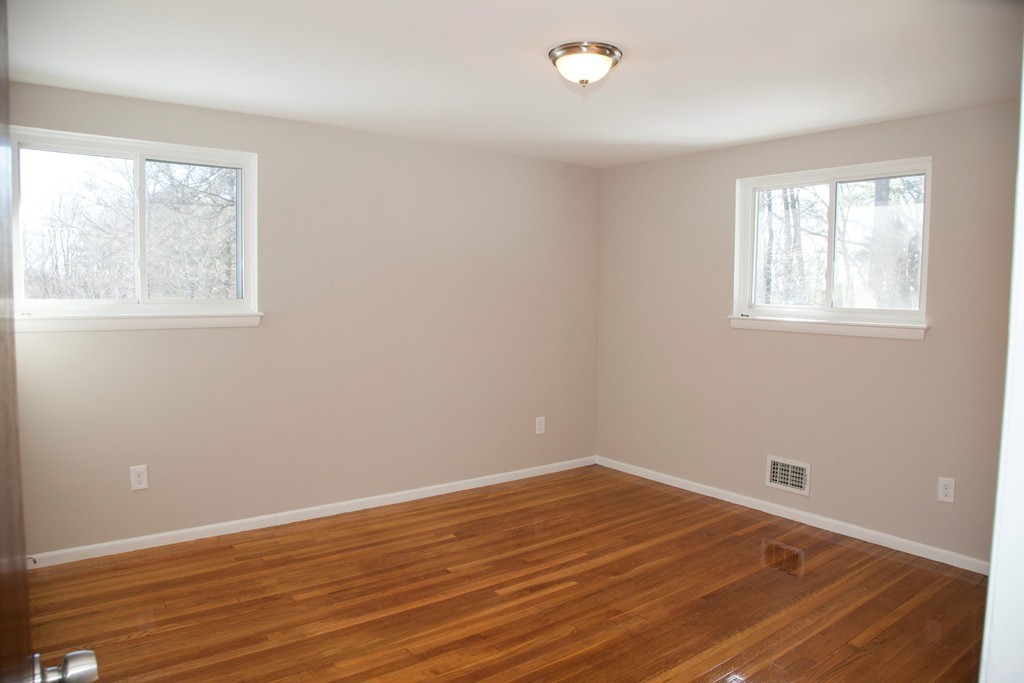 14 McAdams Road Framingham, MA 01701 - Photo 12 of 15 an empty room with wooden floor and windows