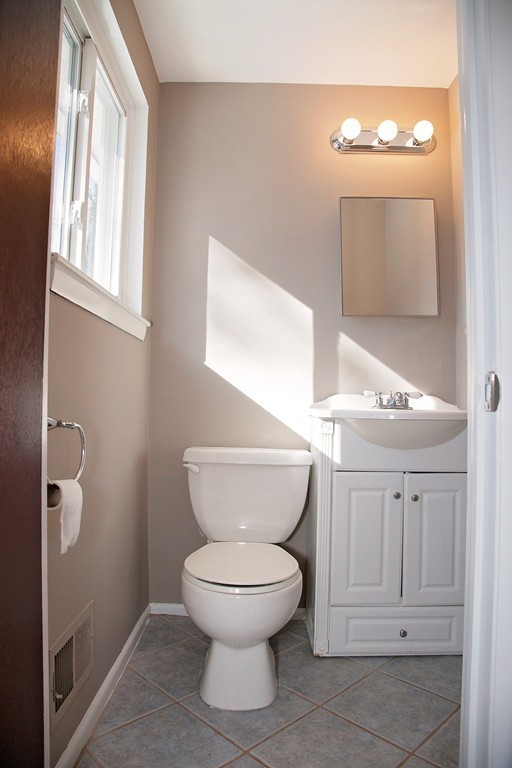 14 McAdams Road Framingham, MA 01701 - Photo 14 of 15 a bathroom with a toilet sink and mirror