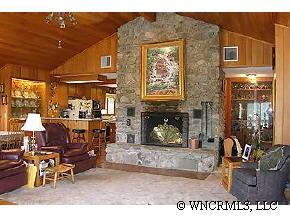 544 Brown Ridge Road Maggie Valley, NC 28751 - Photo 3 of 12 a dining room with furniture and a fireplace