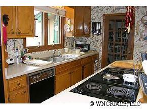 544 Brown Ridge Road Maggie Valley, NC 28751 - Photo 6 of 12 a kitchen with a stove a sink and a microwave