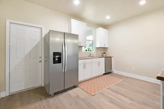 a kitchen with a wooden floor and window