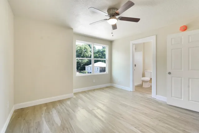 a white toilet sitting next to a shower